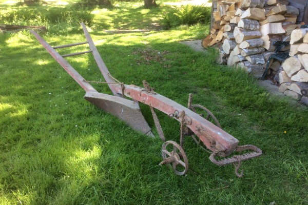 The plough has two wheels: one sits in the furrow; the other sits on top of the furrow. the wheels in the photo are fitted on the wrong side!