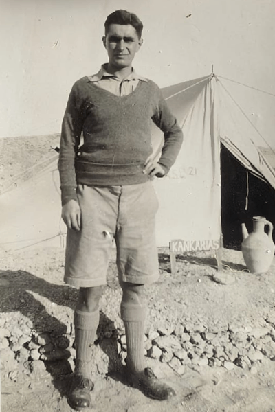 "Outside our tent. Notice how tent is dug in. Earthenware pitcher is semi- porous and used for keeping water cool in the summer months - 20th Feb 1942"