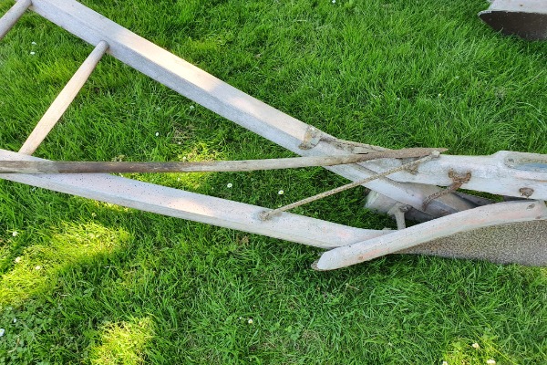 The spudder, shown in the photo lying across the plough, was used to scrape mud off the breast when required.
