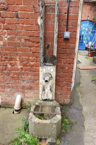 This pump outside the back door was the only water souce into the house until the 1930'?